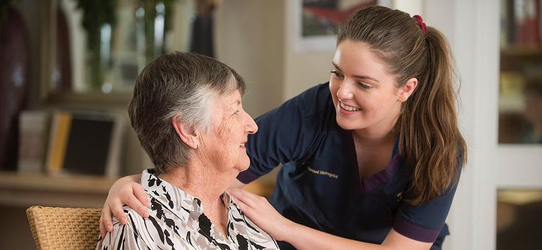 Therapy staff member with resident Therapy staff member with resident